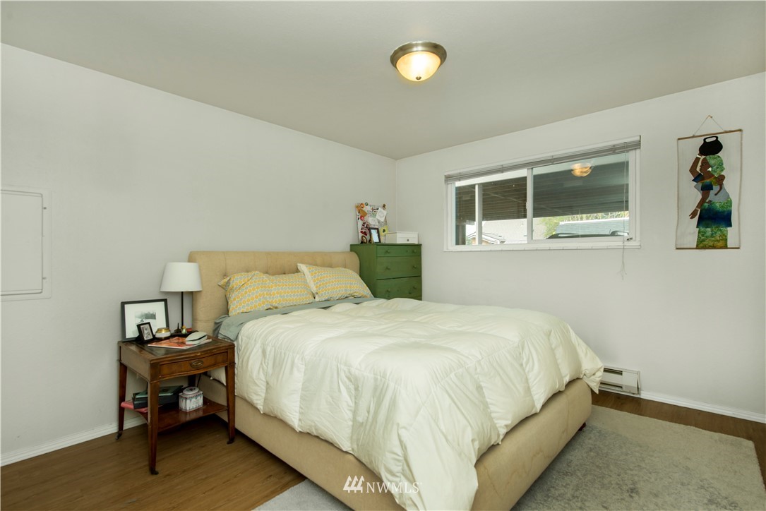 338 Northwest 46th Street Seattle, WA 98107 - Photo 14 of 25 a bedroom with a bed and painting on the wall