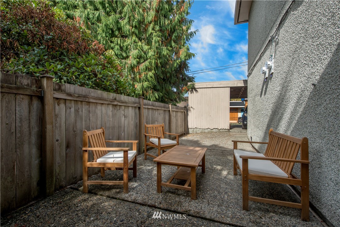 338 Northwest 46th Street Seattle, WA 98107 - Photo 20 of 25 a backyard of a house with table and chairs