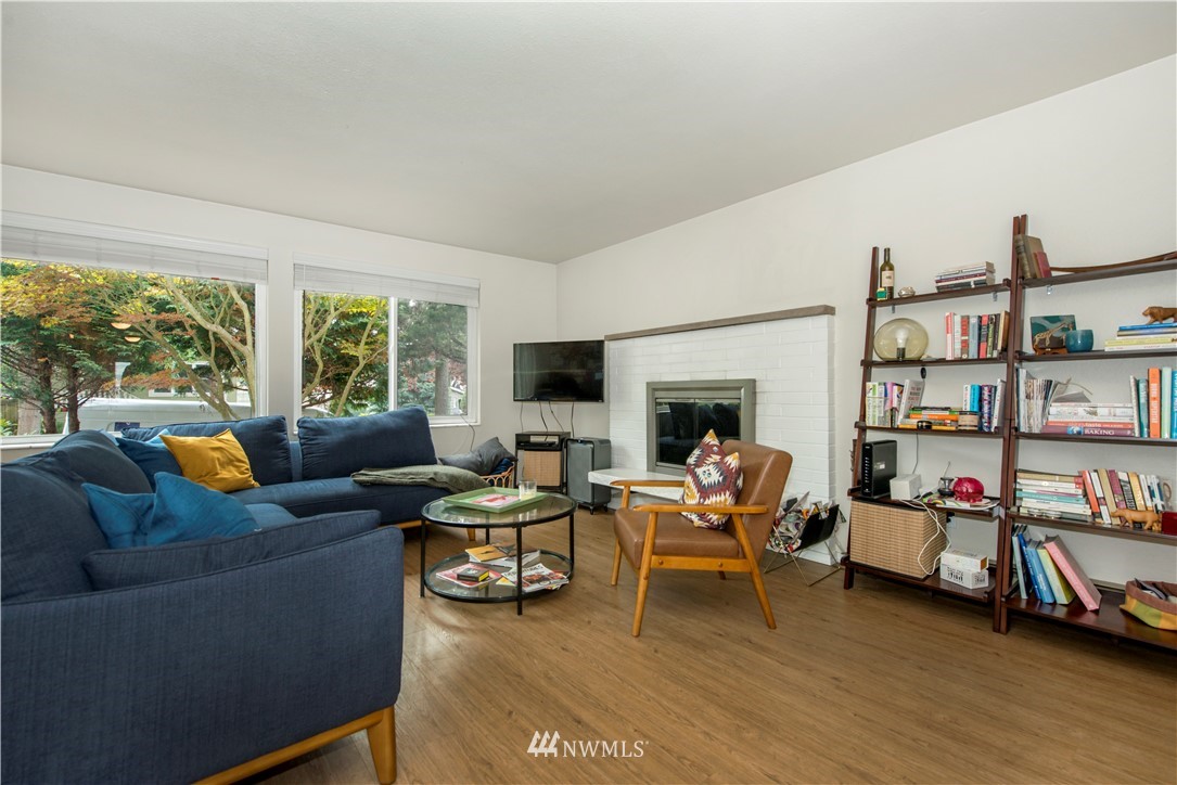 338 Northwest 46th Street Seattle, WA 98107 - Photo 4 of 25 a living room with fireplace furniture and a flat screen tv