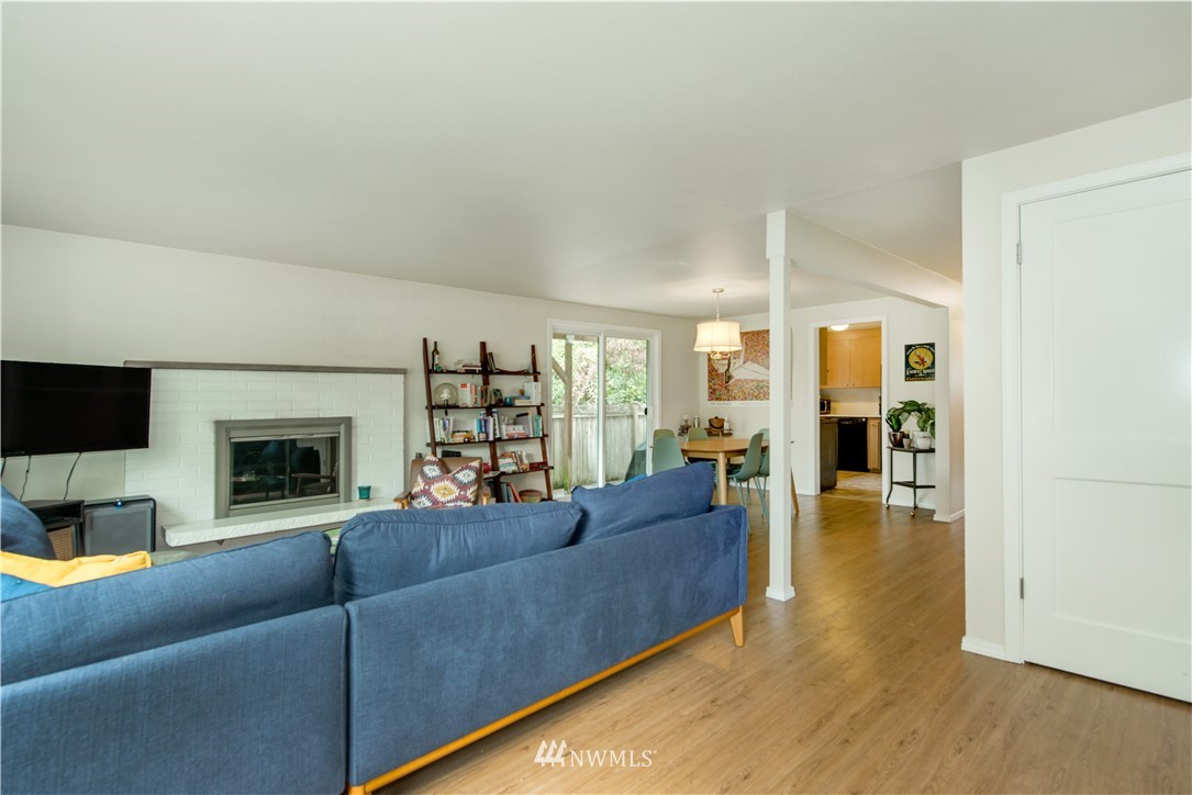 338 Northwest 46th Street Seattle, WA 98107 - Photo 7 of 25 a living room with furniture and a fireplace