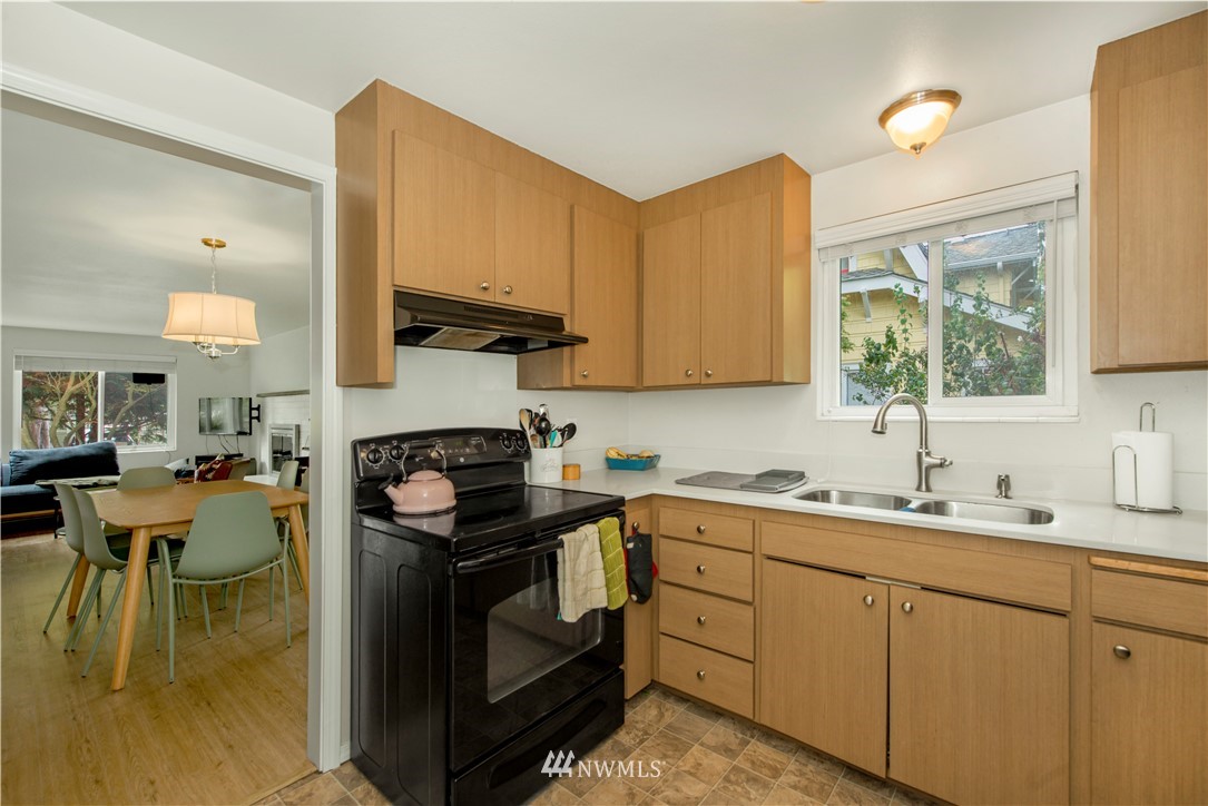 338 Northwest 46th Street Seattle, WA 98107 - Photo 10 of 25 a kitchen with a stove and a sink