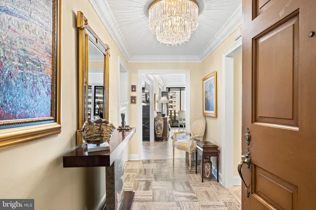 a view of a dining room with furniture and a chandelier
