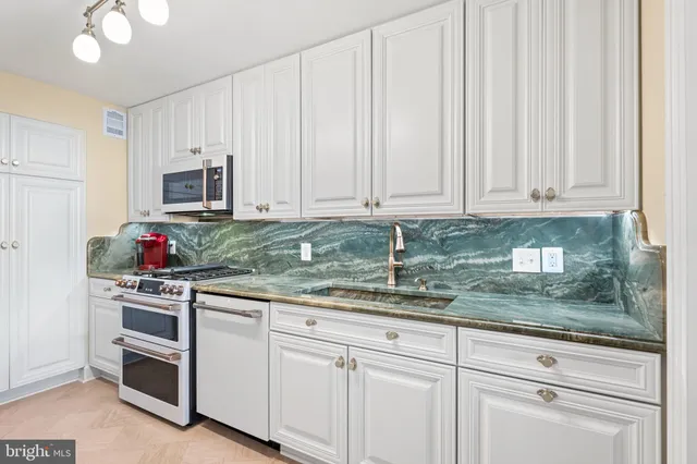 a bathroom with a sink a mirror and shower