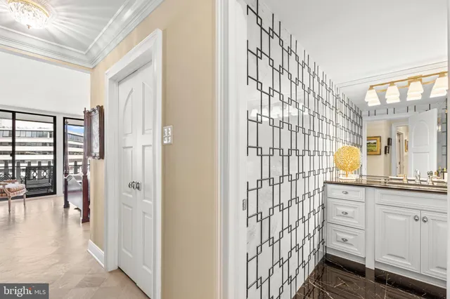 a bedroom with a bed and a flat tv screen on dresser