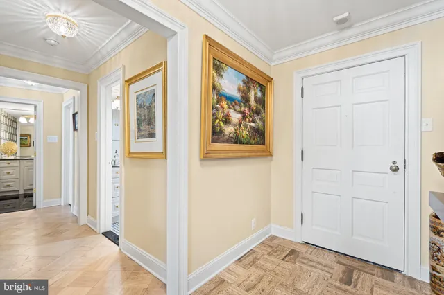 a view of a hallway with wooden floor and closet