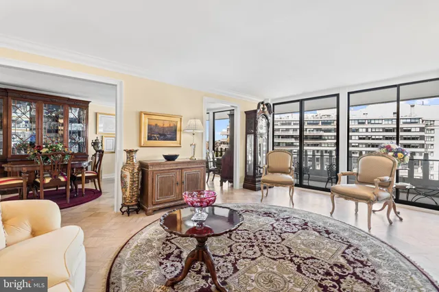 a living room with furniture and a floor to ceiling window