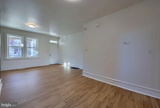 wooden floor in an empty room with a window