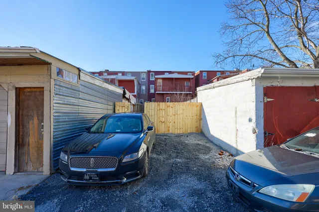 a view of a backyard with wooden fence