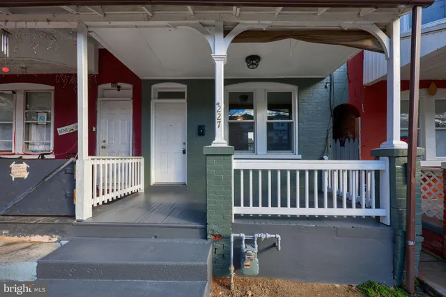 a front view of a residential apartment building with a yard