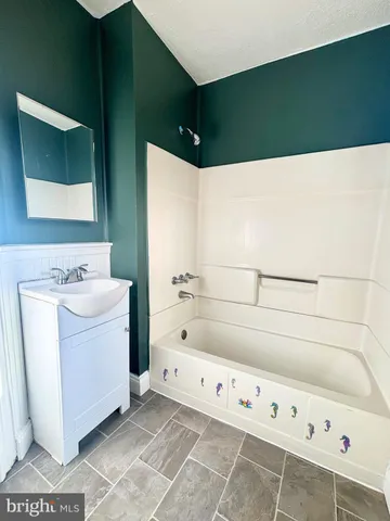 a bathroom with a bathtub and a sink