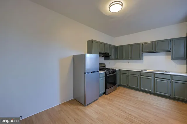 a kitchen with granite countertop a stove and a refrigerator