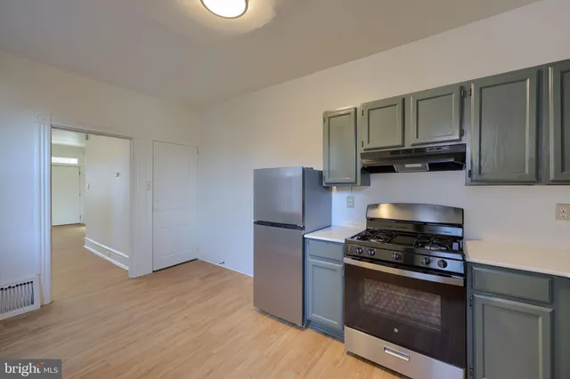 a kitchen with a refrigerator and a sink
