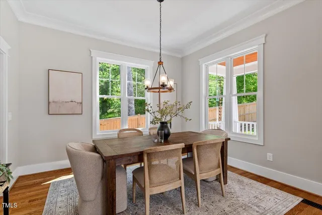 a kitchen with stainless steel appliances granite countertop a sink a stove and a wooden floors