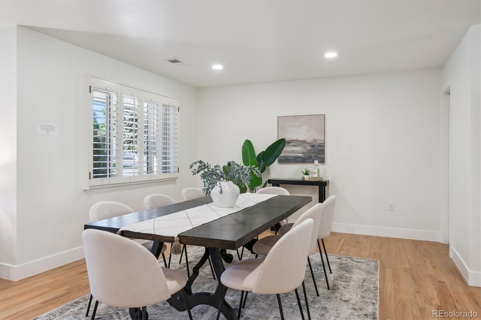 3775 South Forest Way Denver, CO 80237 - Photo 13 of 40 a view of a dining room with furniture and wooden floor