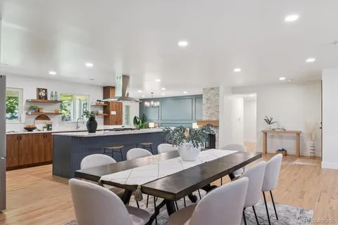 a dining room with furniture and wooden floor