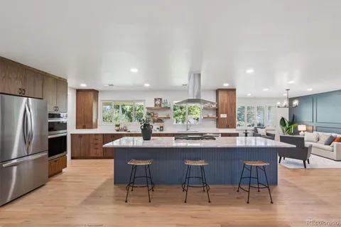 a kitchen with a table and chairs stainless steel appliances
