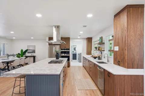 a kitchen with stainless steel appliances kitchen island granite countertop a sink and cabinets