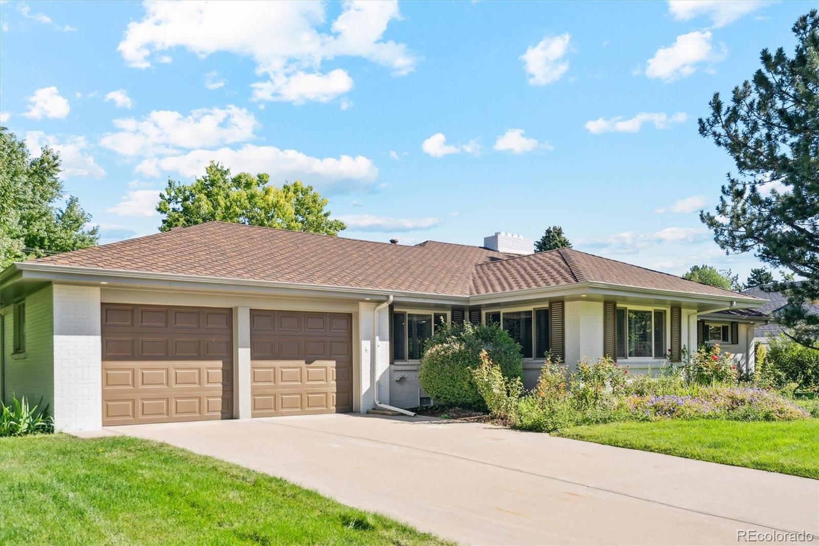 3775 South Forest Way Denver, CO 80237 - Photo 2 of 40 a front view of a house with a garden