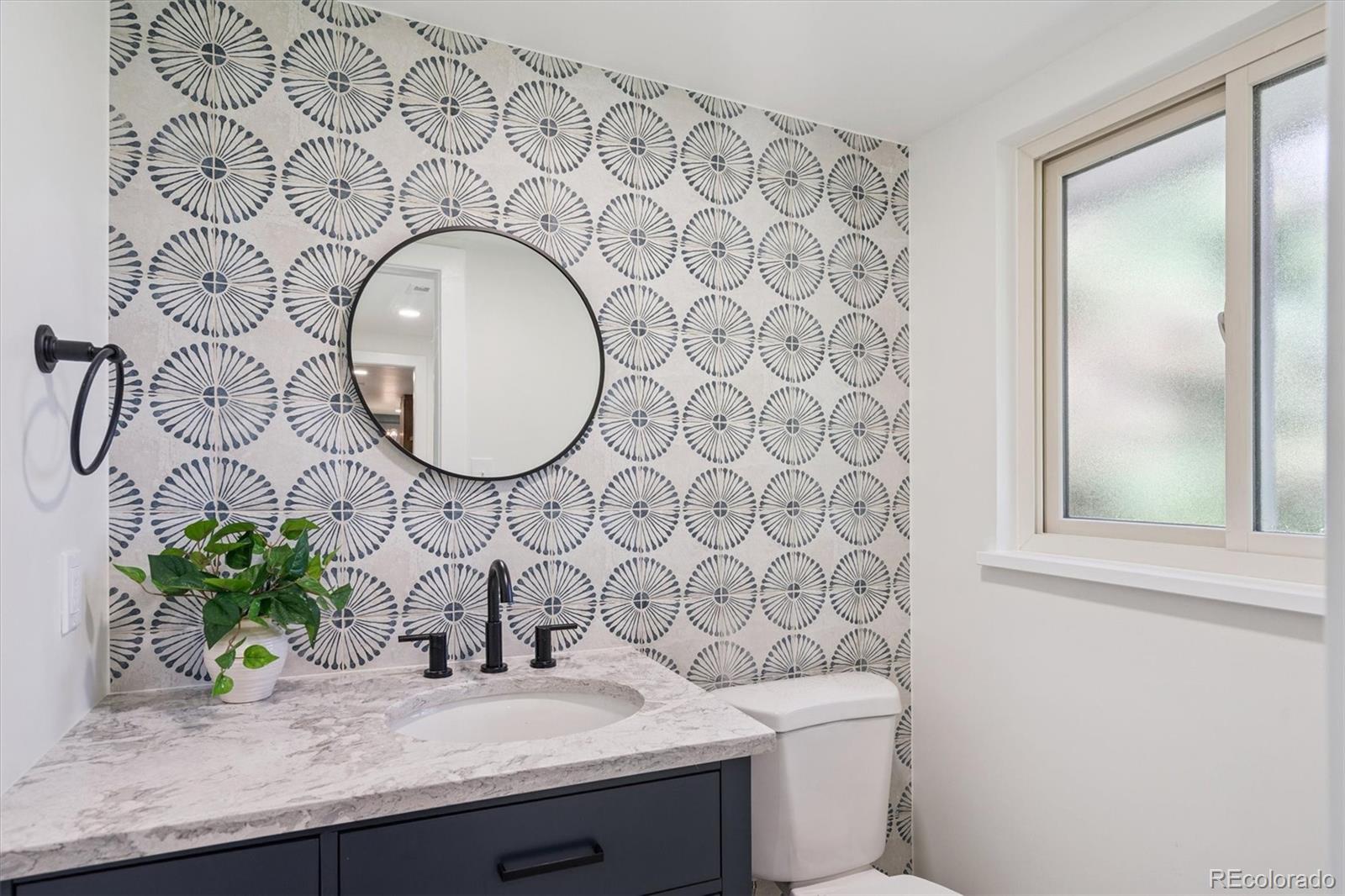 3775 South Forest Way Denver, CO 80237 - Photo 24 of 40 a bathroom with a granite countertop sink and a mirror