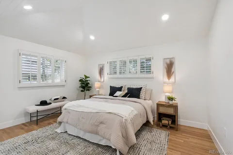 a bedroom with a bed table and a window