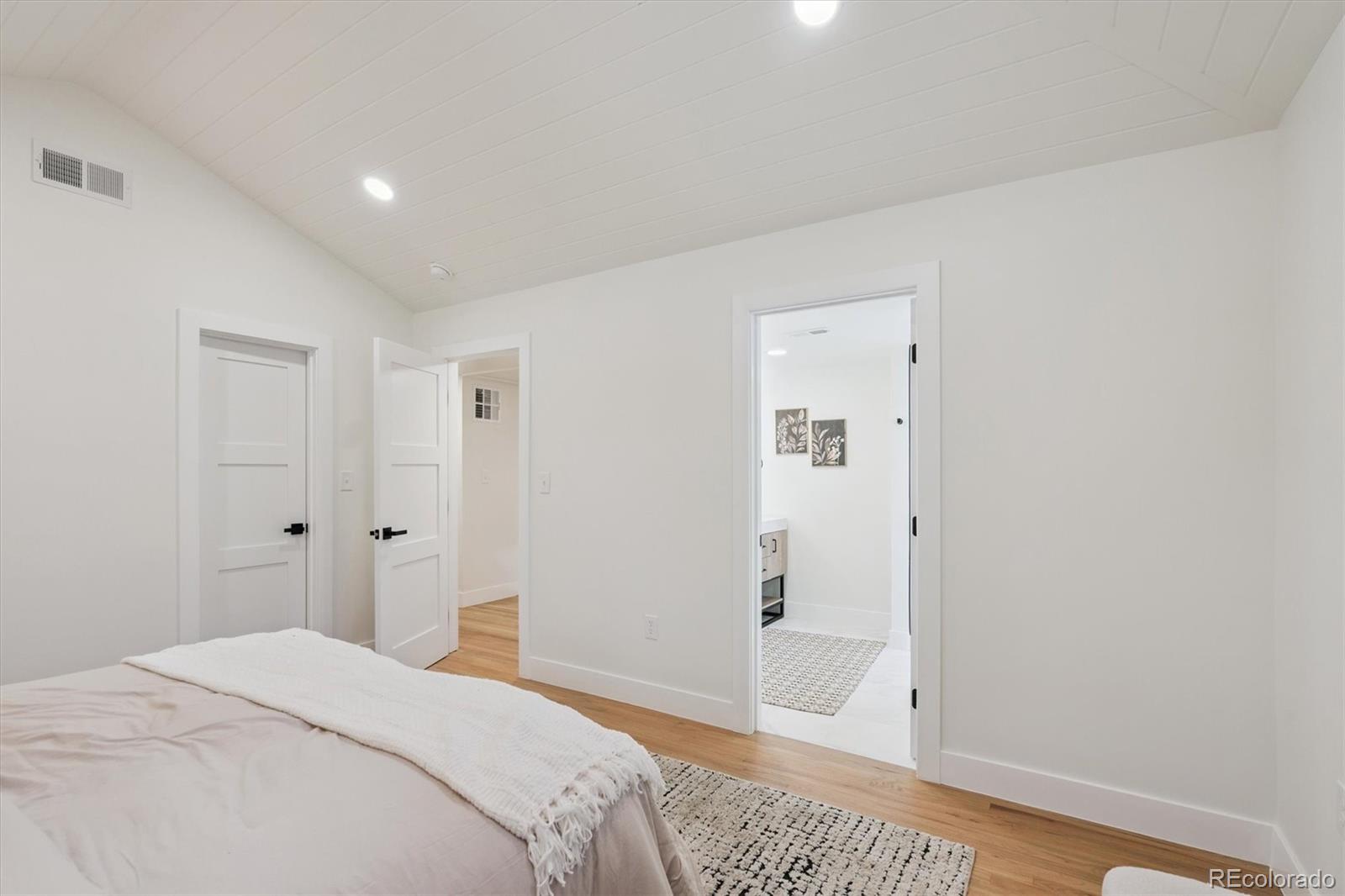 3775 South Forest Way Denver, CO 80237 - Photo 26 of 40 a bedroom with a bed and wooden floor