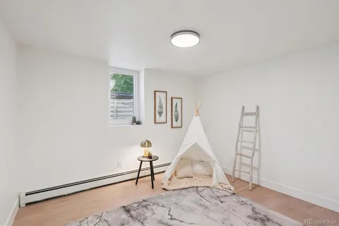 a view of a livingroom with wooden floor and a window