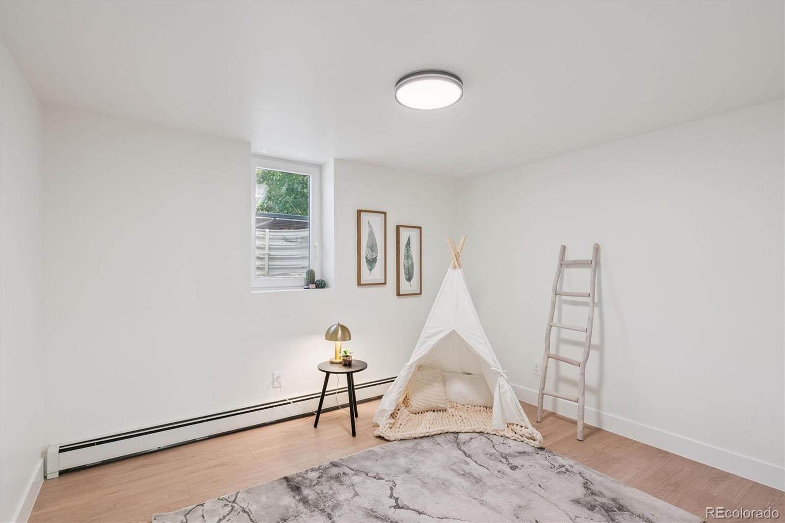 3775 South Forest Way Denver, CO 80237 - Photo 35 of 40 a view of a livingroom with wooden floor and a window