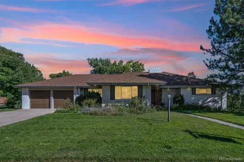 a front view of house with a garden