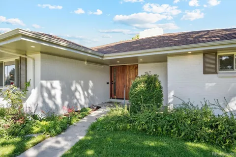 a front view of a house with plants