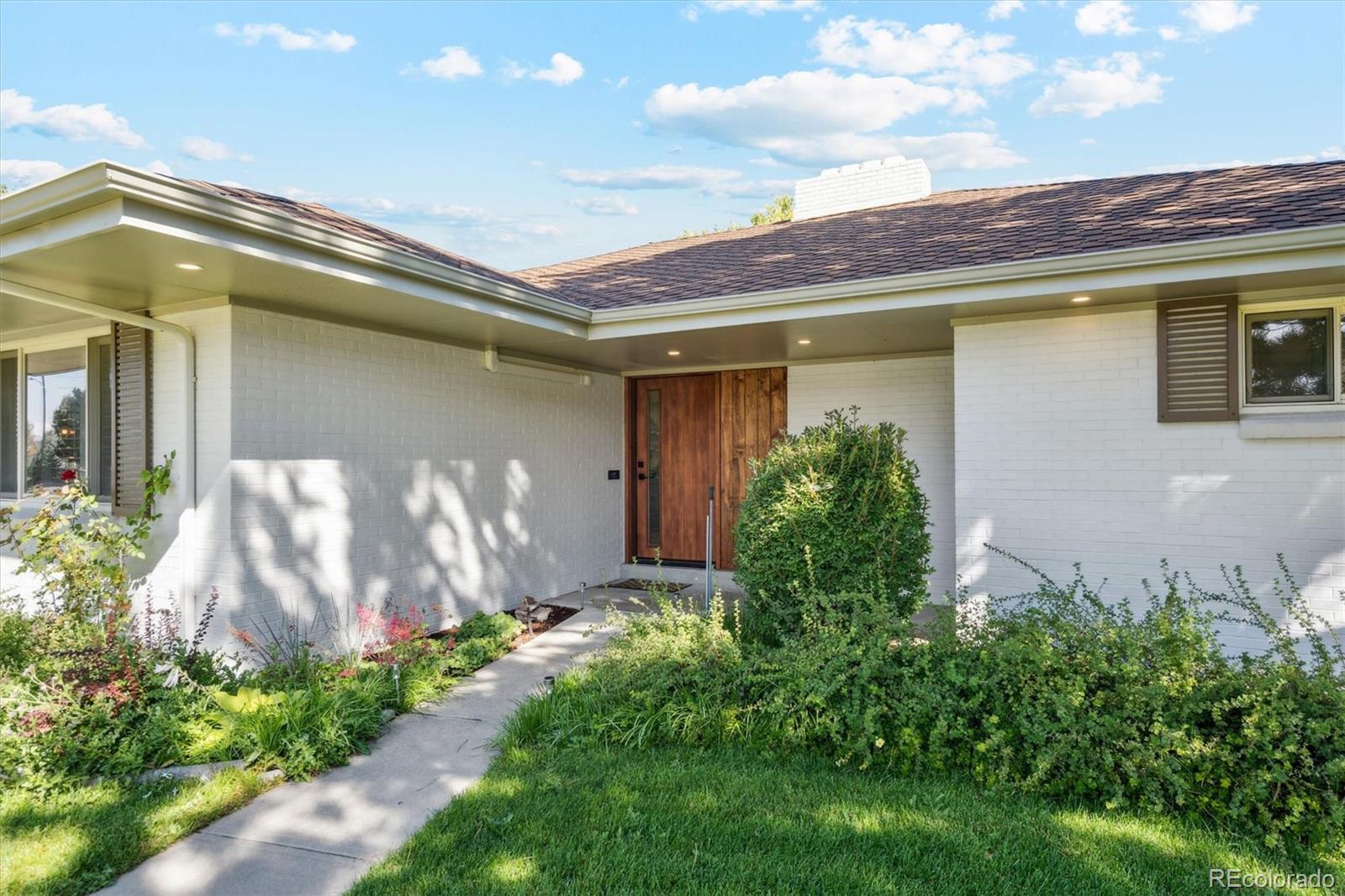 3775 South Forest Way Denver, CO 80237 - Photo 4 of 40 a front view of a house with plants