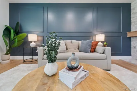 a living room with furniture and potted plant