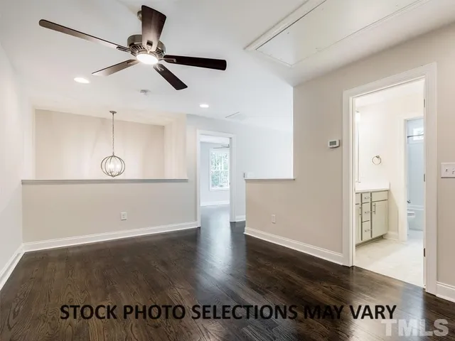 a view of a room with wooden floor and windows