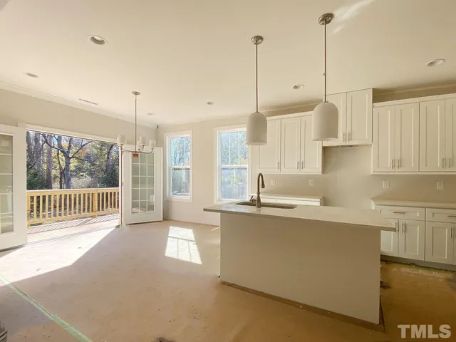 a kitchen with stainless steel appliances granite countertop a sink a stove and a window