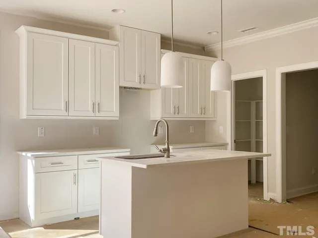 a kitchen with stainless steel appliances granite countertop a sink a refrigerator and a granite counter tops