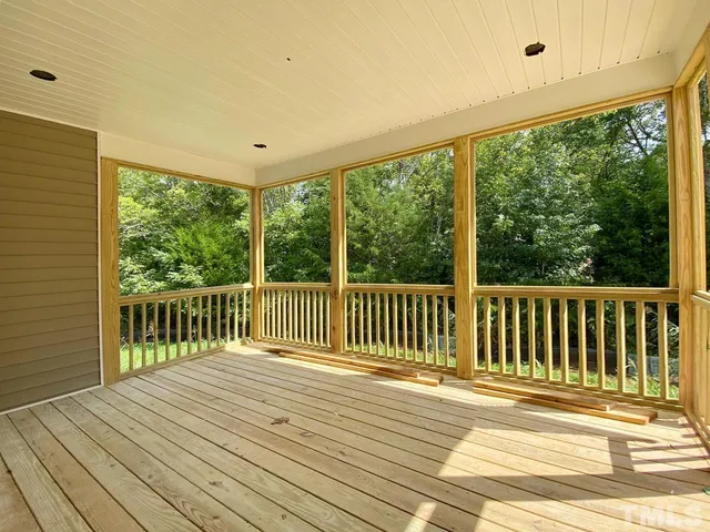a view of a balcony with wooden floor