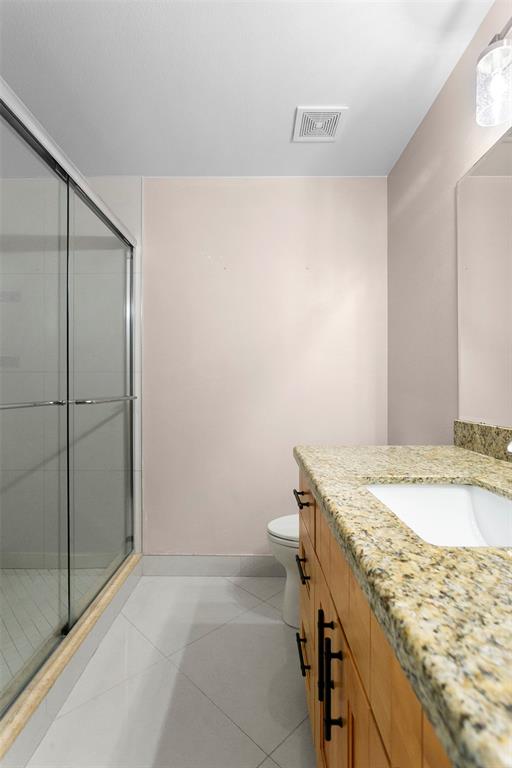 1431 Southwest 48th Terrace, Unit 1431 Deerfield Beach, FL 33442 - Photo 14 of 22 a bathroom with a granite countertop sink and toilet