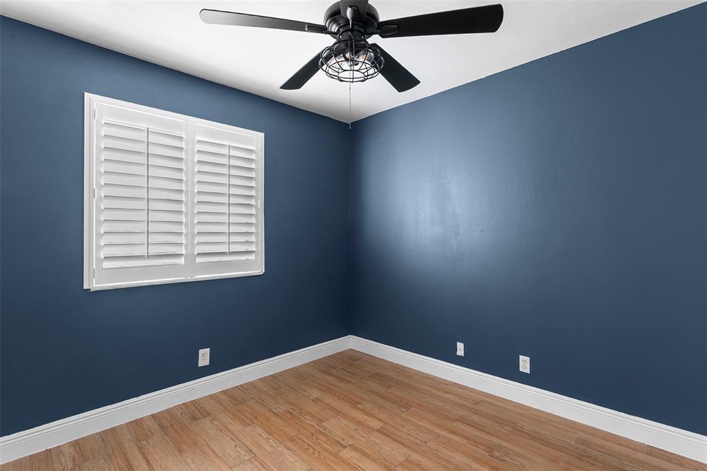 1431 Southwest 48th Terrace, Unit 1431 Deerfield Beach, FL 33442 - Photo 16 of 22 a view of an empty room with window and wooden floor
