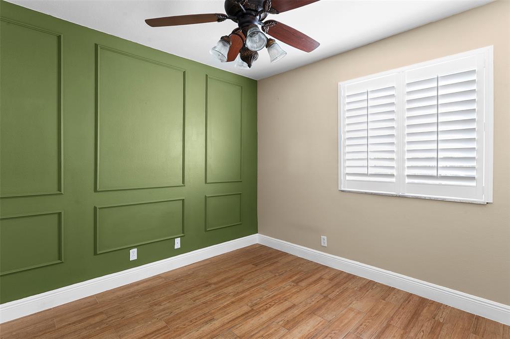 1431 Southwest 48th Terrace, Unit 1431 Deerfield Beach, FL 33442 - Photo 18 of 22 an empty room with wooden floor closet and windows