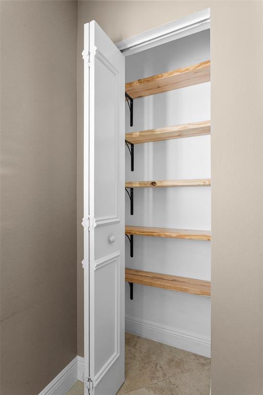 1431 Southwest 48th Terrace, Unit 1431 Deerfield Beach, FL 33442 - Photo 5 of 22 a view of walk in closet with empty racks