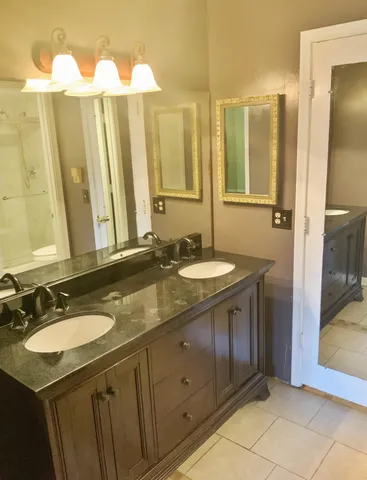a bathroom with a double vanity sink and a mirror