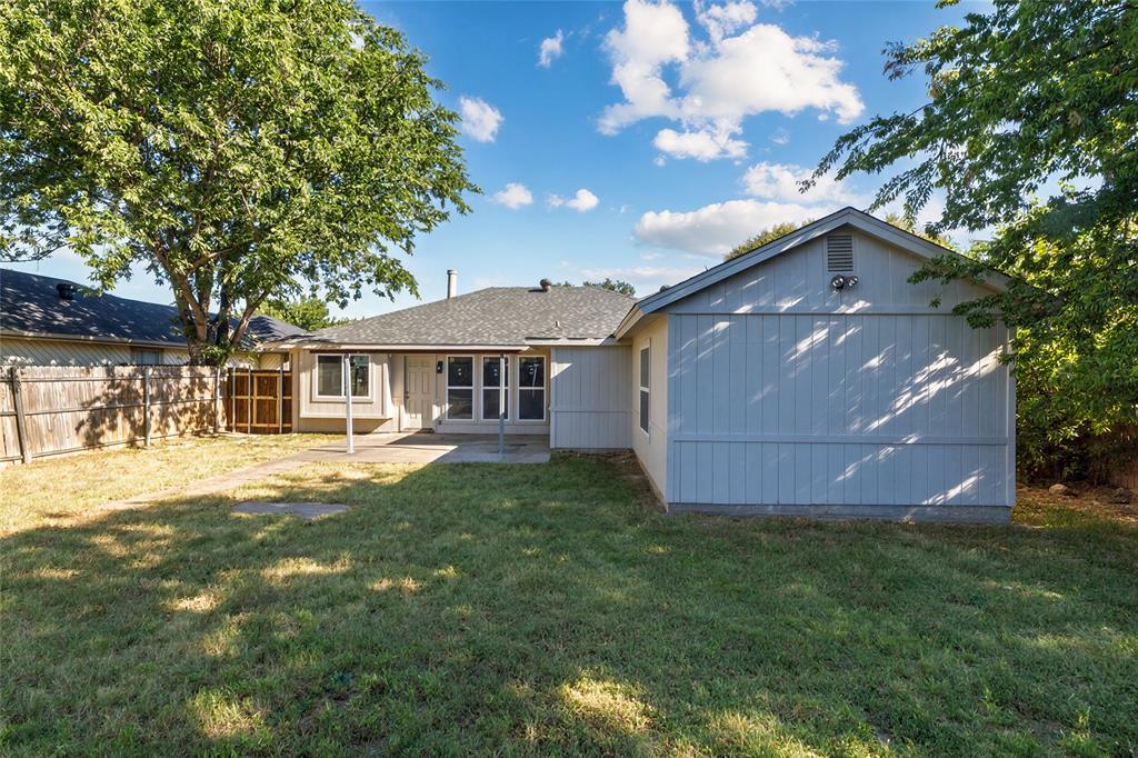 2513 Poplar Spring Road Fort Worth, TX 76123 - Photo 40 of 40 Expansive backyard featuring a concrete patio, mature trees, and a wood privacy fence