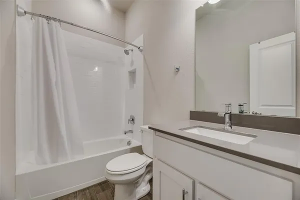 a bedroom with a bed tv and a chandelier