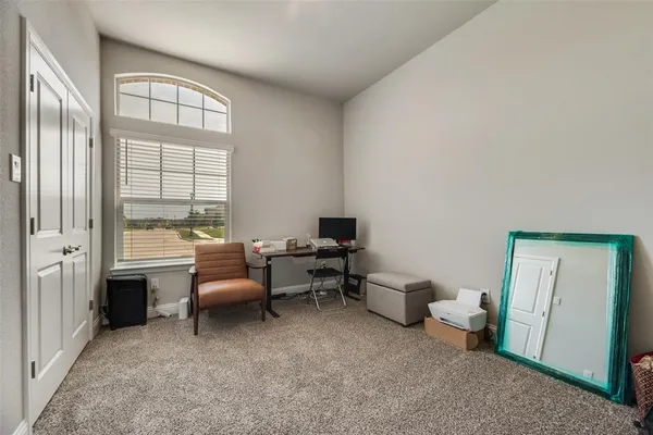 a room with a baby crib and a window