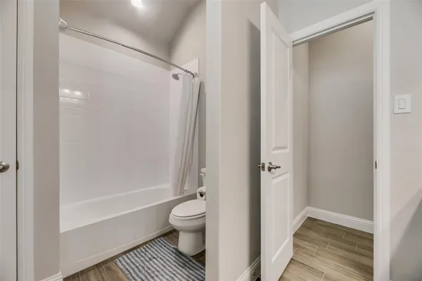 a spacious bedroom with a bed and a ceiling fan