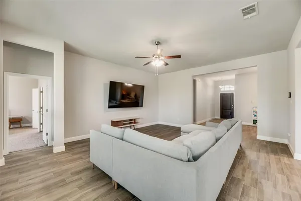 a large kitchen with kitchen island a stove a sink a refrigerator and cabinets