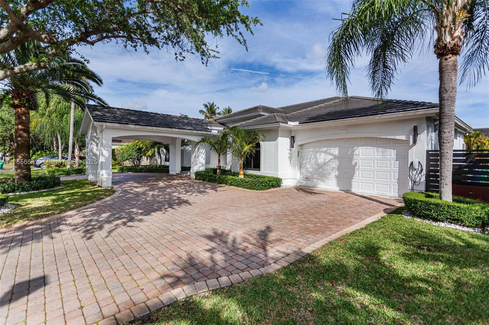 9491 Southwest 124th Terrace Miami, FL 33176 - Photo 1 of 26 a front view of a house with a yard and garage