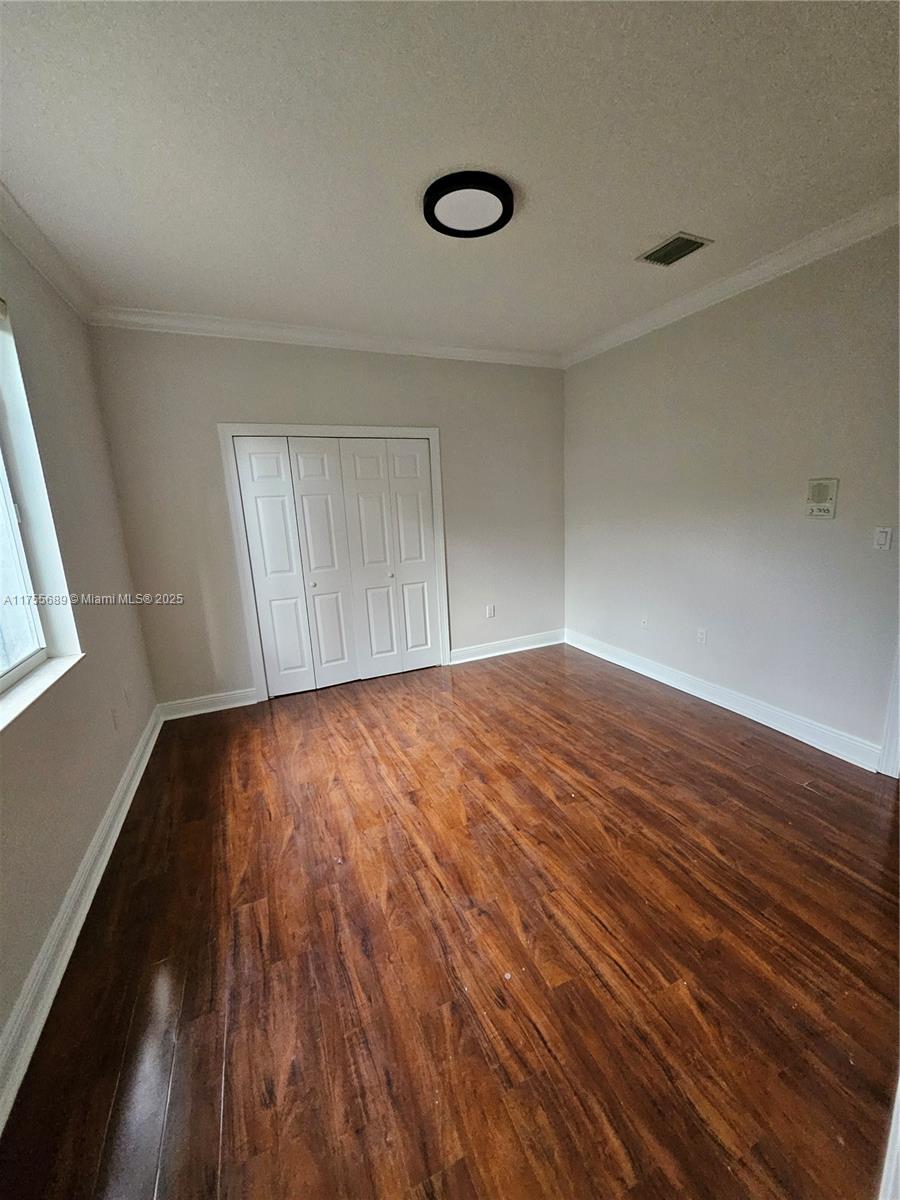 9491 Southwest 124th Terrace Miami, FL 33176 - Photo 11 of 26 a view of empty room with wooden floor