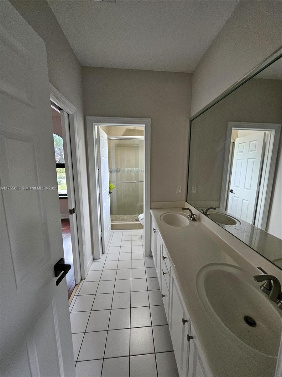 9491 Southwest 124th Terrace Miami, FL 33176 - Photo 12 of 26 a bathroom with a tub sink and mirror