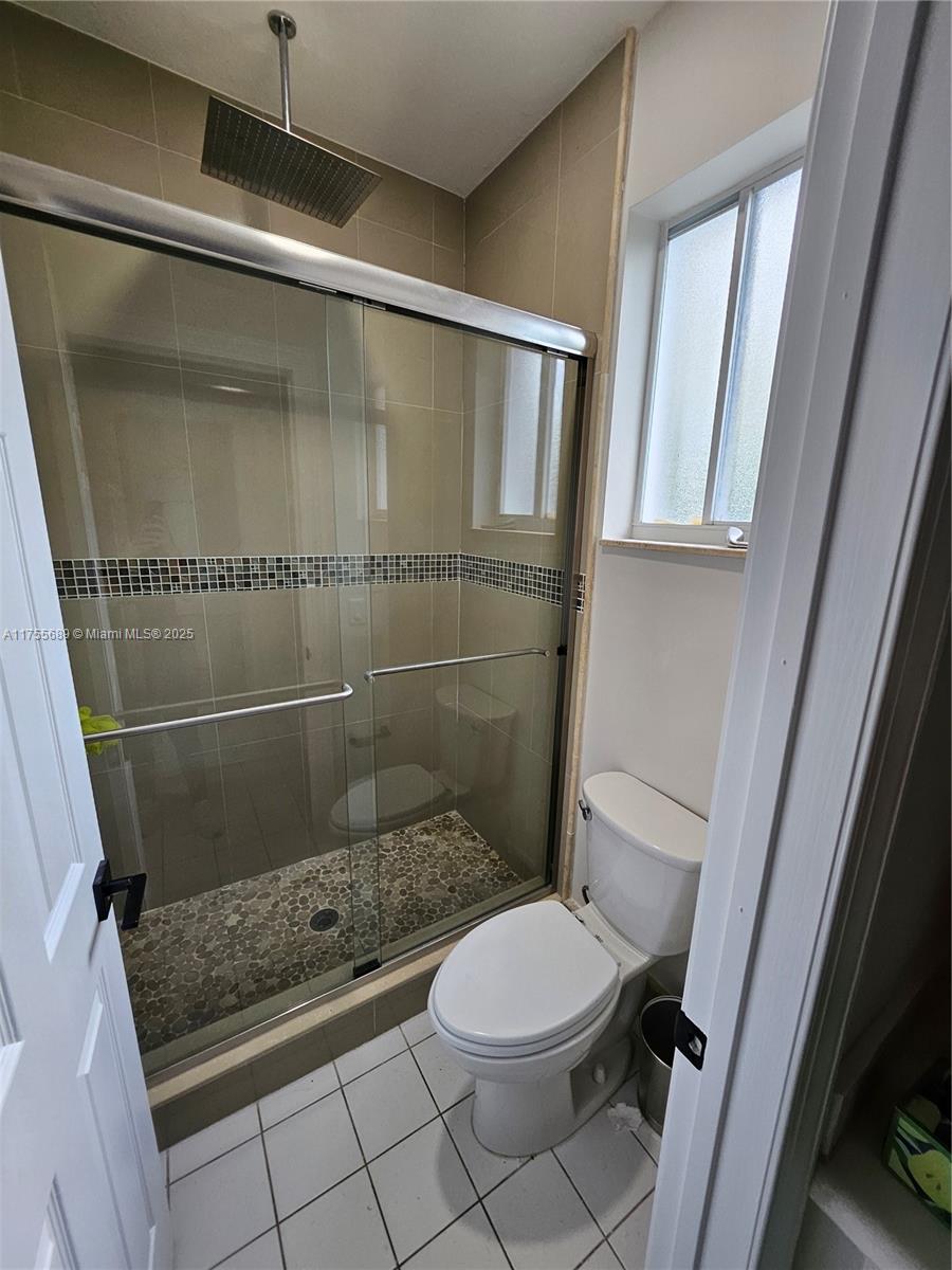 9491 Southwest 124th Terrace Miami, FL 33176 - Photo 13 of 26 a bathroom with a shower and a toilet