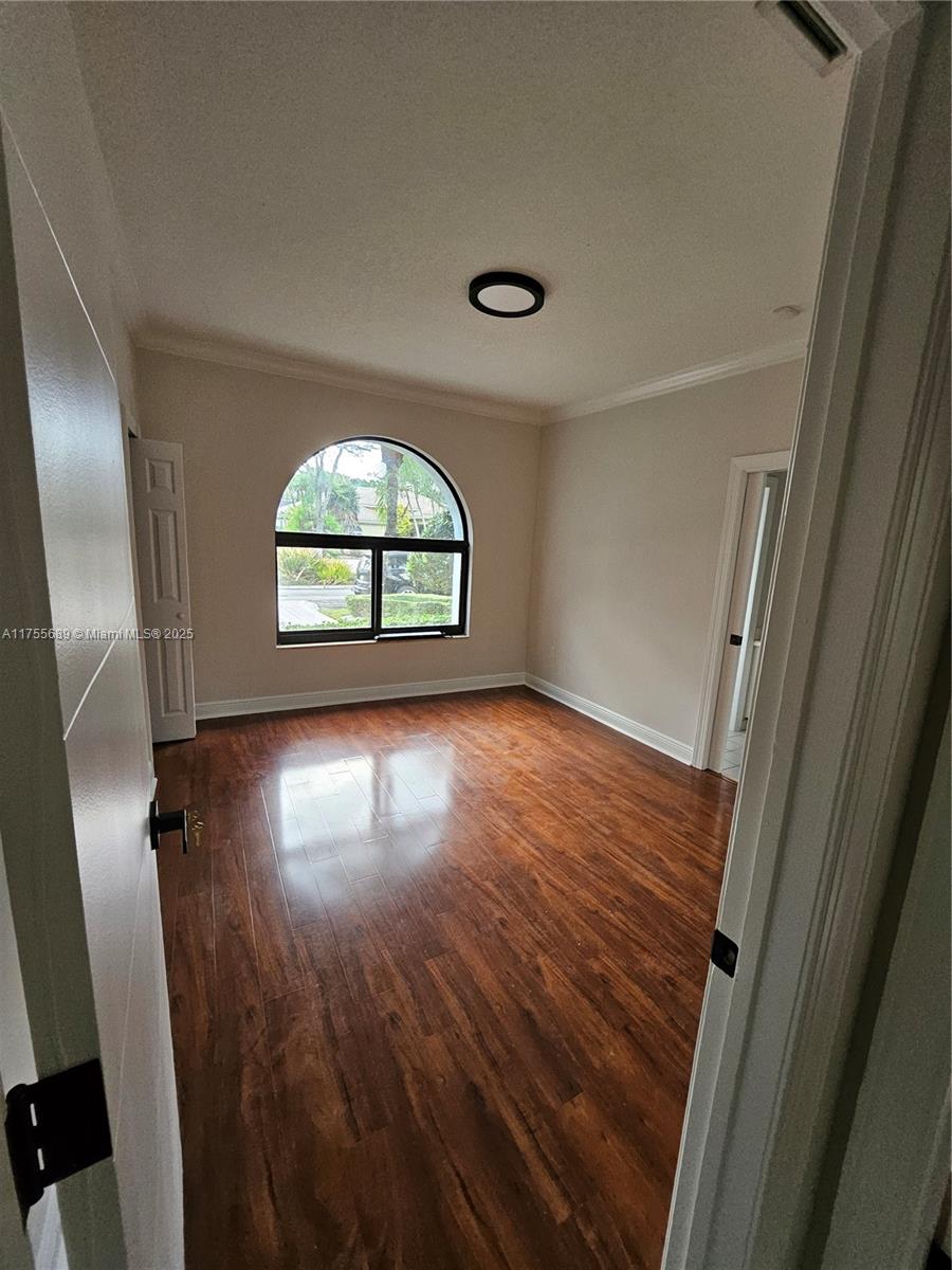 9491 Southwest 124th Terrace Miami, FL 33176 - Photo 15 of 26 an empty room with wooden floor and windows